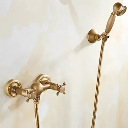 Antique brass bathtub shower set with ceramic handles featuring an antique brass-finished faucet and matching handheld showerhead