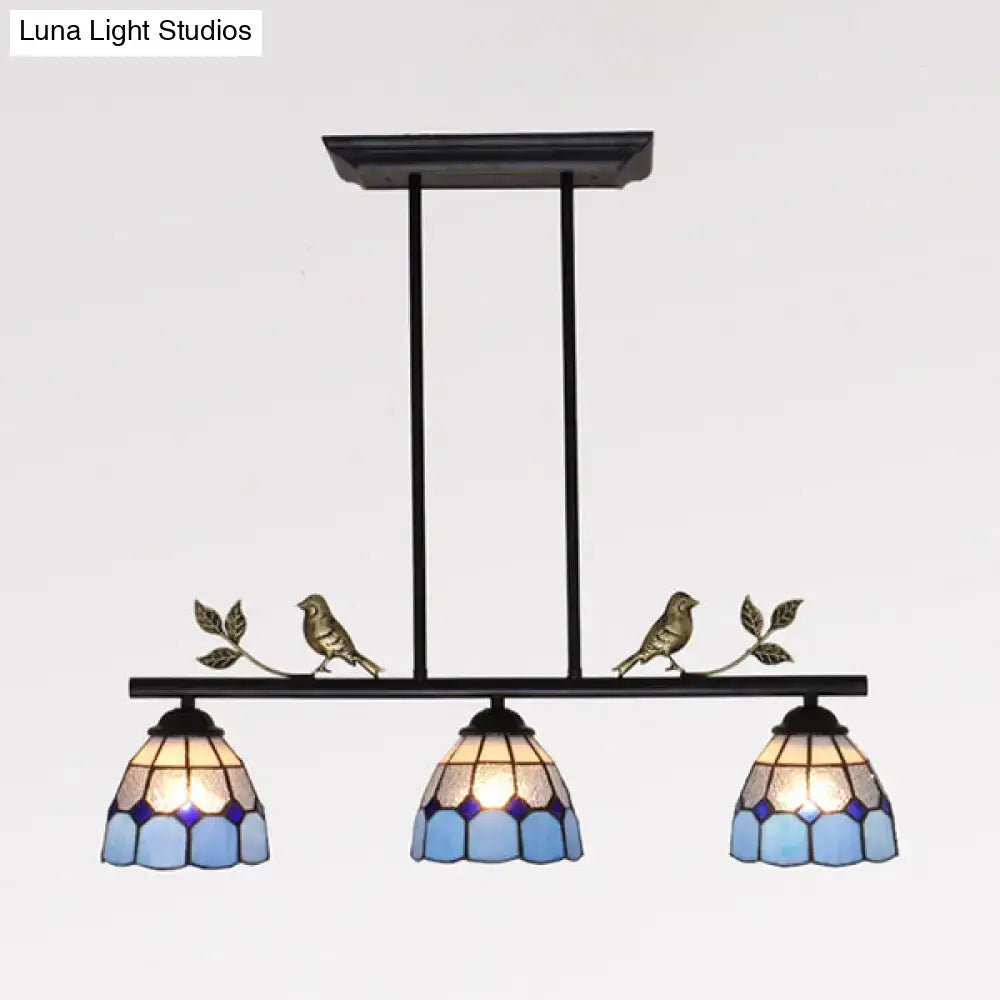 Black metal indoor island pendant with three blue and purple stained glass shades and brass bird figurines