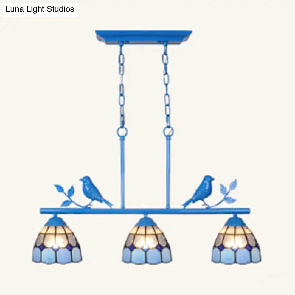 Blue stained glass three-light indoor island pendant with antique brass finish and bird branch accents stainless glass shade