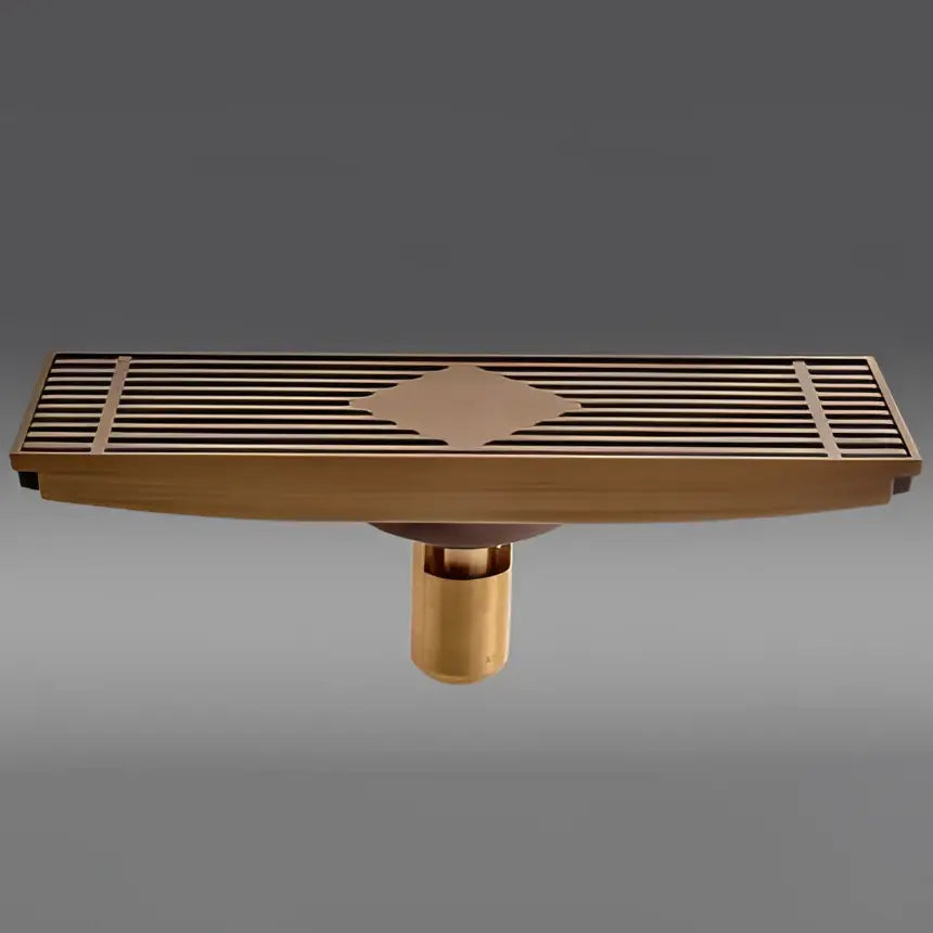 Antique brass carved rectangular floor drain cover with diamond-shaped inlay and slatted design for bathroom drainage