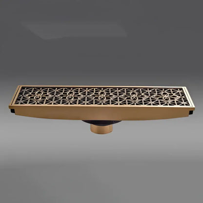 Antique brass carved floor drain cover with intricate geometric floral pattern brass-colored rectangular drain cover