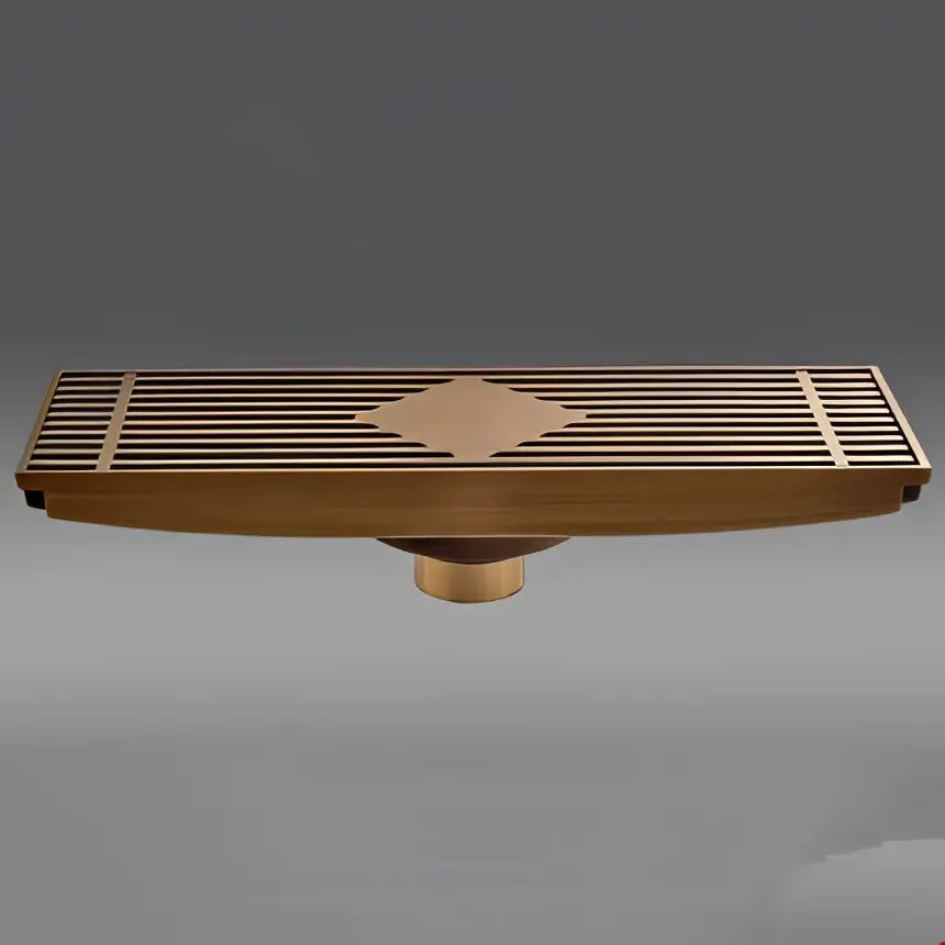 Antique brass carved floor drain cover with diamond-shaped inlay and slatted design for bathroom drainage use