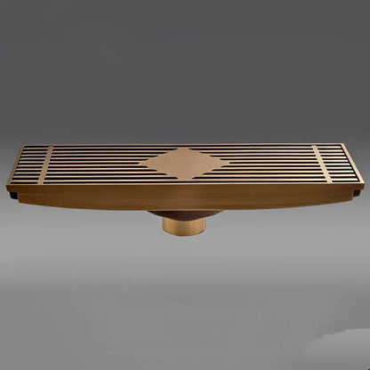 Antique brass carved floor drain cover with diamond-shaped inlay and slatted design for bathroom drainage use
