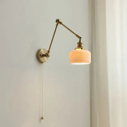 Brass-finished adjustable wall light with ribbed warm glass shade and pull-chain switch decorbites ceramic copper led bedroom sconce