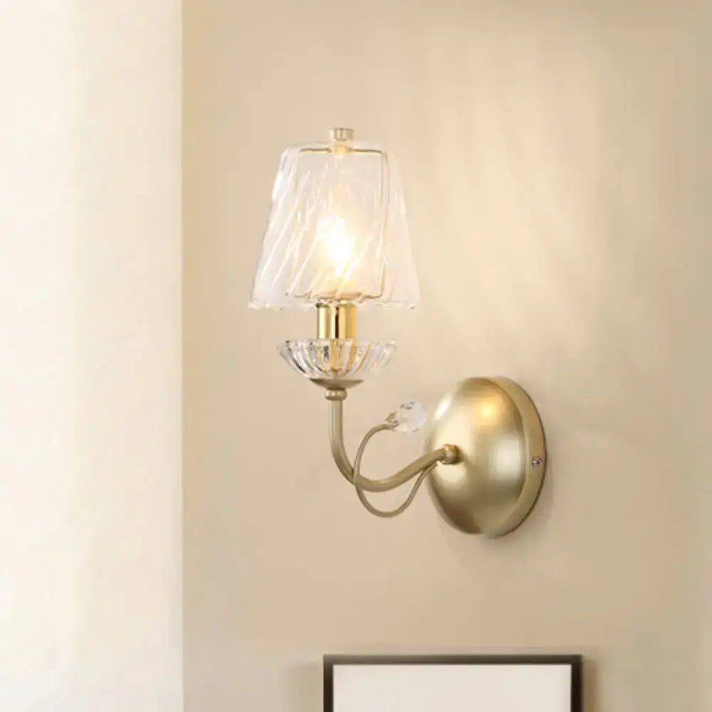 Antique brass conical sconce light with clear twisted glass shade and crystal accents for bedroom use