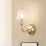 Antique brass conical sconce light with clear twisted glass shade and crystal accents for bedroom use