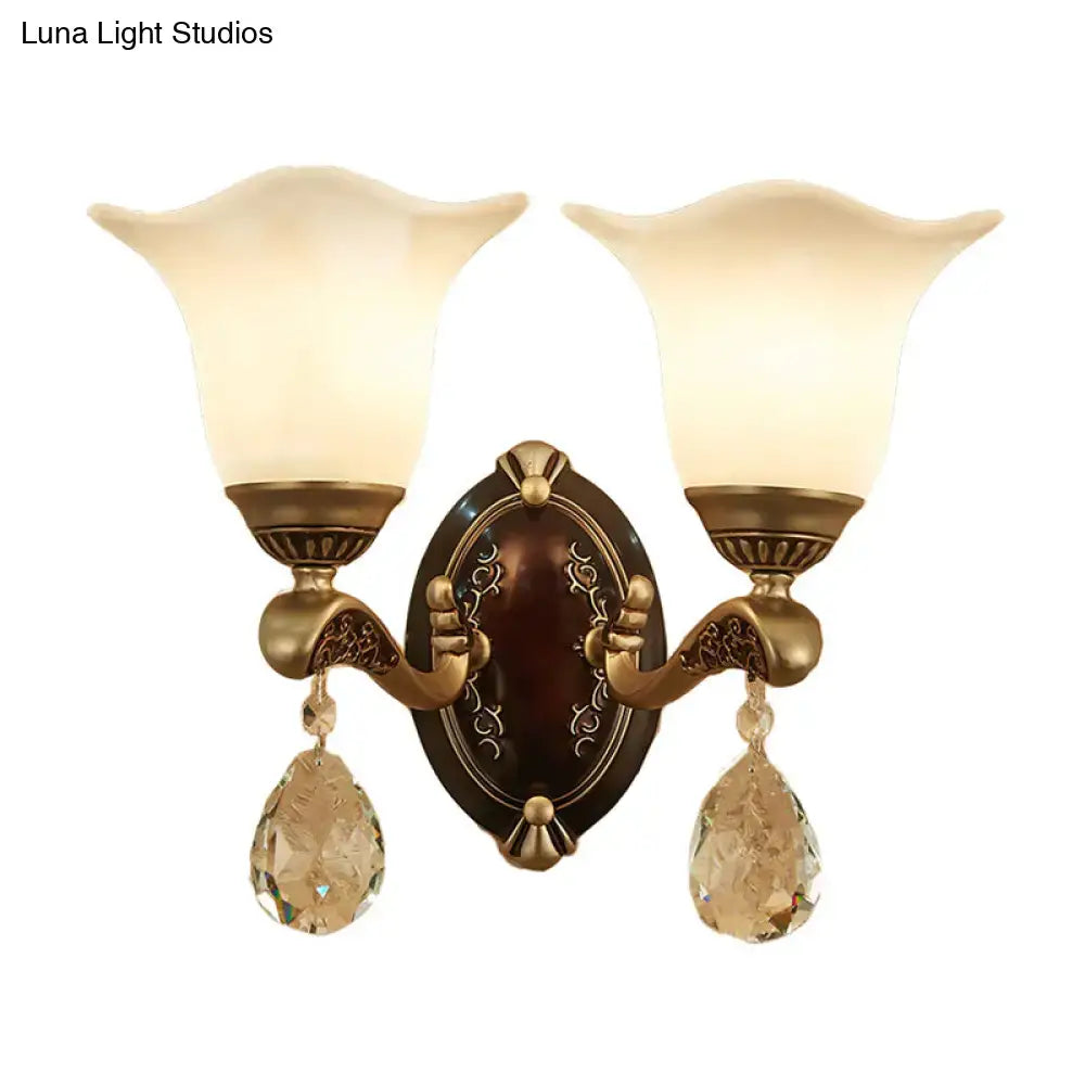Antique brass two-light wall lamp with frosted glass shades crystal drop pendants and e12 e14 base for bedroom use
