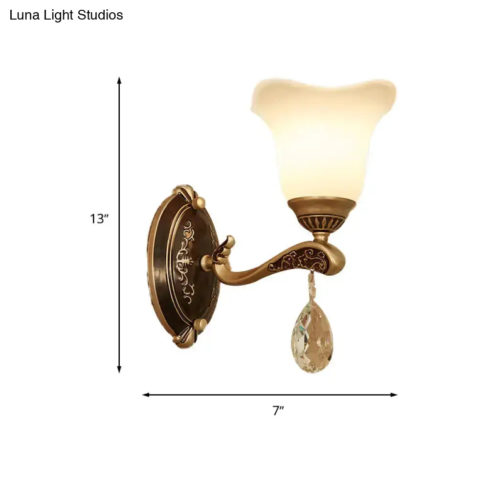 Antique brass crystal drop wall lamp with ornate curved arm and teardrop pendant with e12 e14 base for bedroom sconce