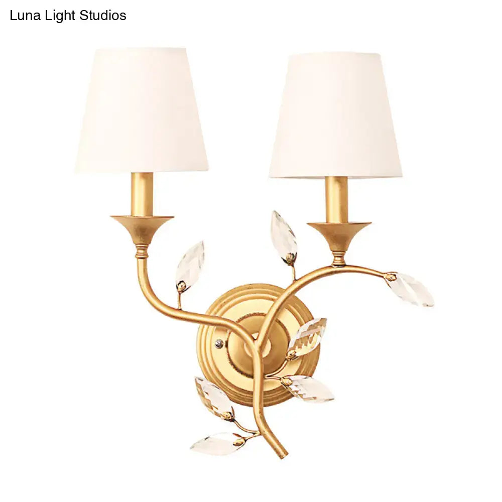 Antique brass wall mount lamp with gold-toned finish crystal leaf accents and two off-white lampshades for bedroom