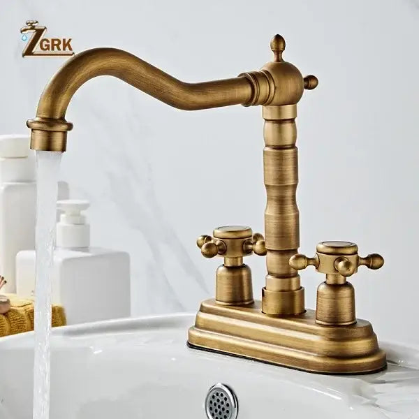 Antique brass deck mounted basin sink faucet with vintage housing material and double cross-handle controls curved spout