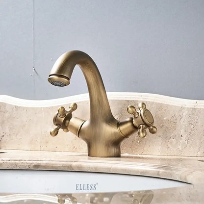 Antique brass dual handle basin faucet with curved spout and cross-shaped knobs for bathroom vanity sink by decorbites