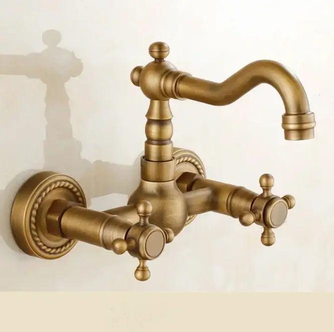 Antique brass dual handle kitchen faucet with ornate detailing and porcelain plate for hot water use