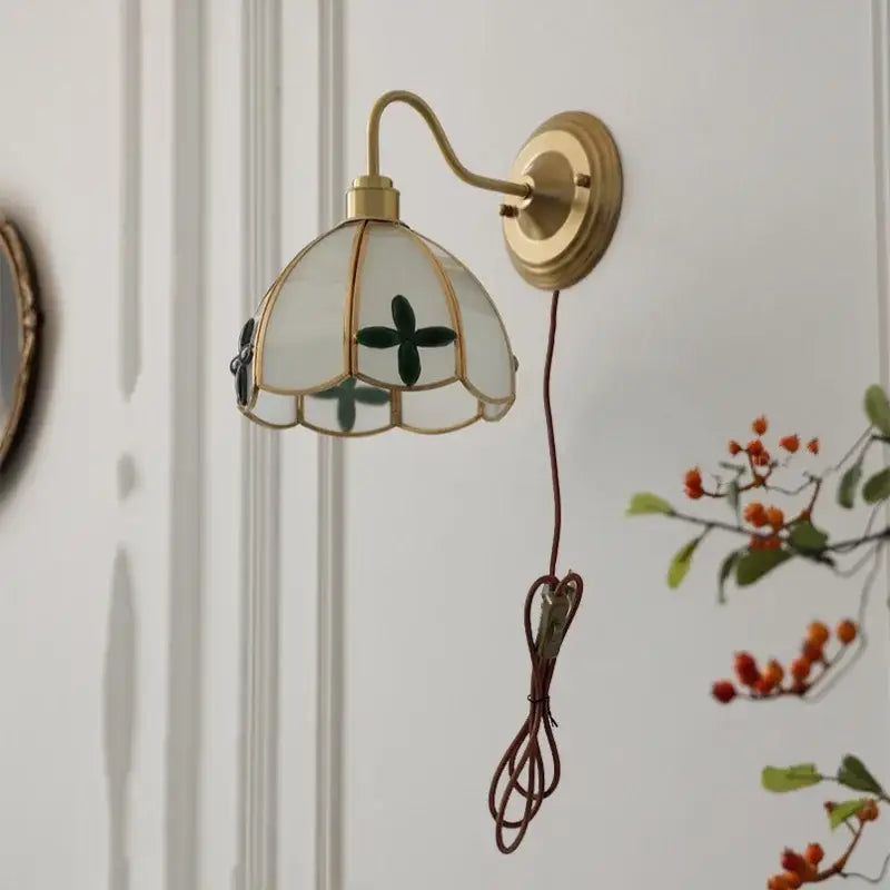 Antique brass glass brass wall sconce with petal-shaped shade and green clover motifs for dining room decorbites