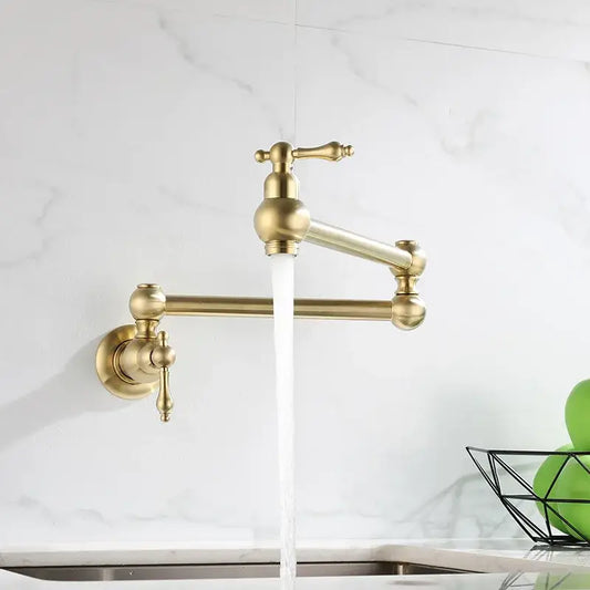 Antique brass gooseneck pot filler tap with ornate handles and sleek curved spout for kitchen wall mounting