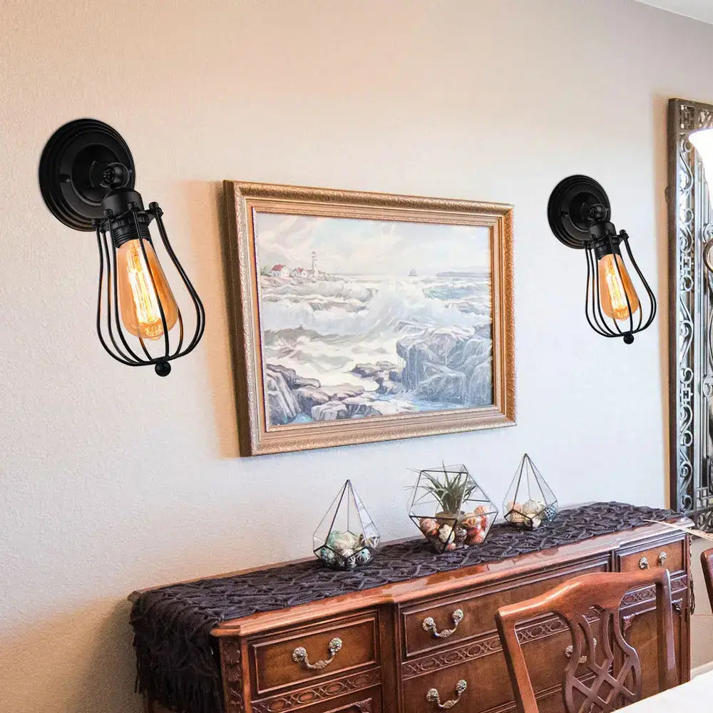 Black wrought iron industrial wall lamp with exposed filament bulbs and wire cage decorbites industrial wall sconce