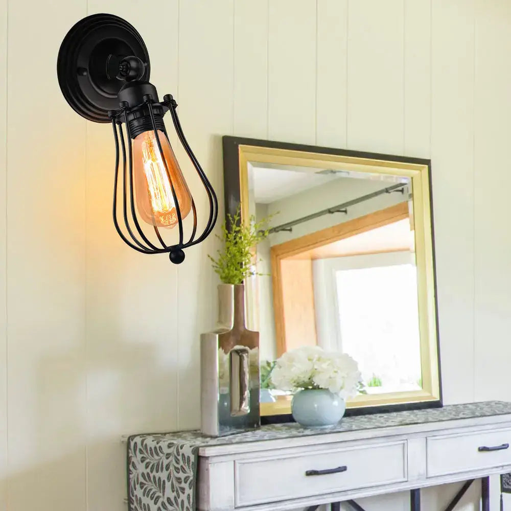 Black wrought iron industrial wall lamp with amber filament bulb and wire cage decorbites industrial wall sconce