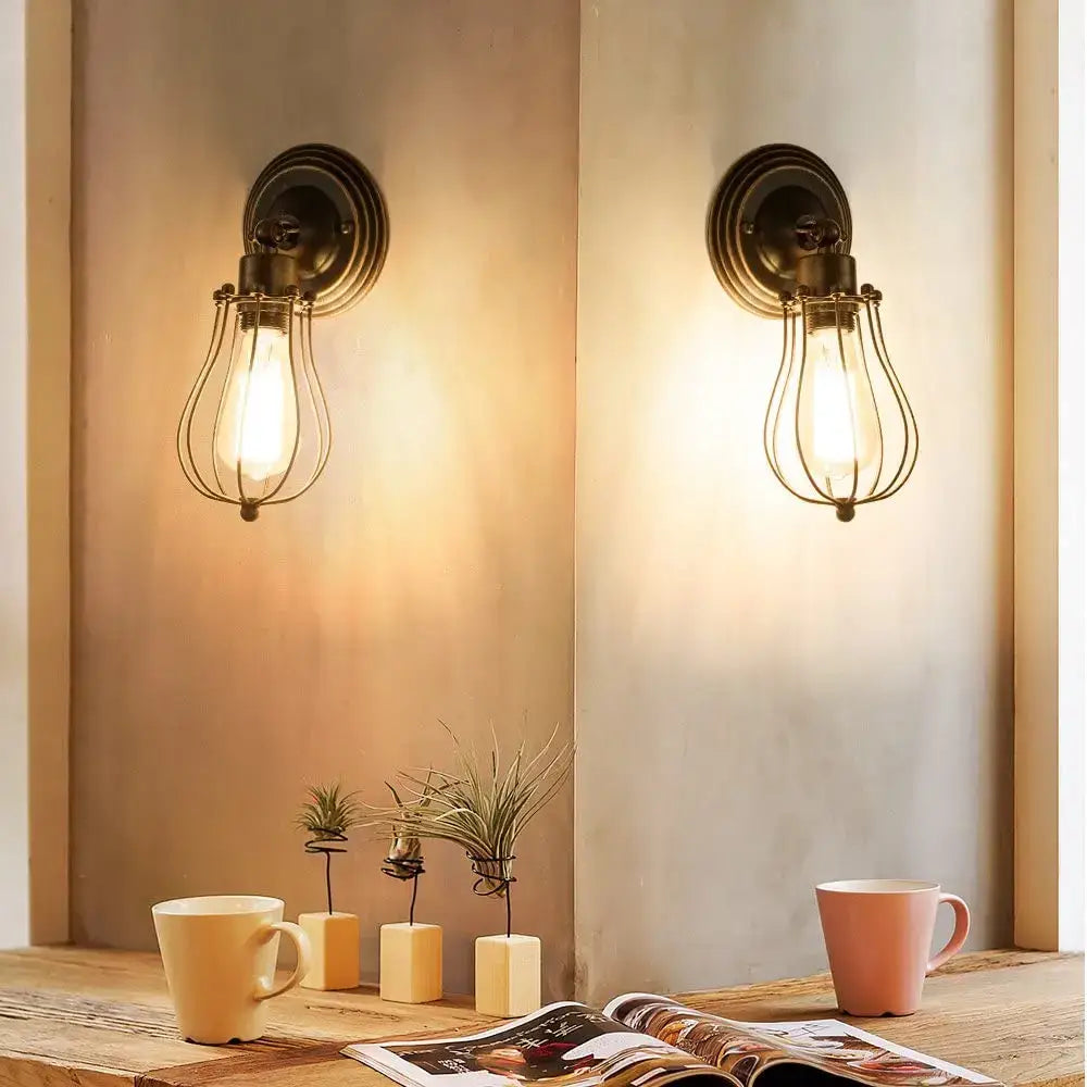Vintage industrial wall lamp with antique brass finish and wire cages housing exposed edison bulbs for bedroom decorbites industrial wall lighting
