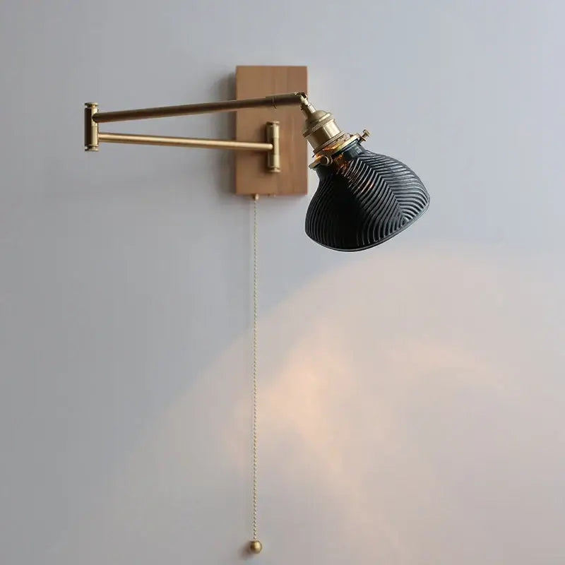 Antique brass industrial wall light with clear glass featuring a sleek black ribbed glass lamp on wooden backplate decorbites clear glass
