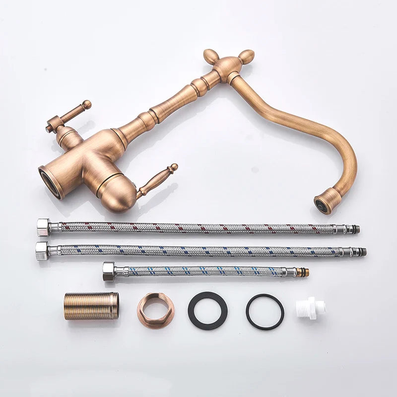 Antique brass kitchen faucet with dual ornate cross handles, curved spout, flexible braided hoses, and mounting hardware