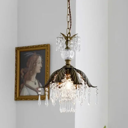 Antique brass leaf crystal pendant light featuring dangling crystal droplets and faceted glass orb for bedroom decor