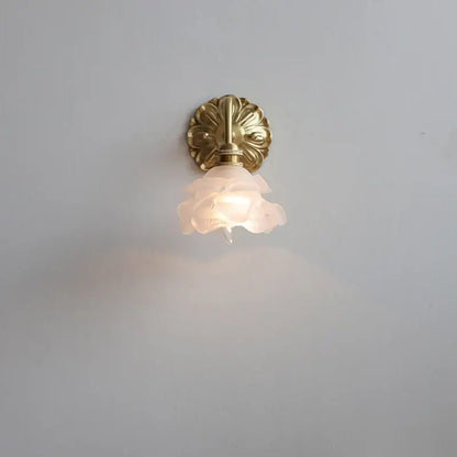 Antique brass wall lamp with a pink rose frosted glass shade by decorbites for elegant bedroom decor