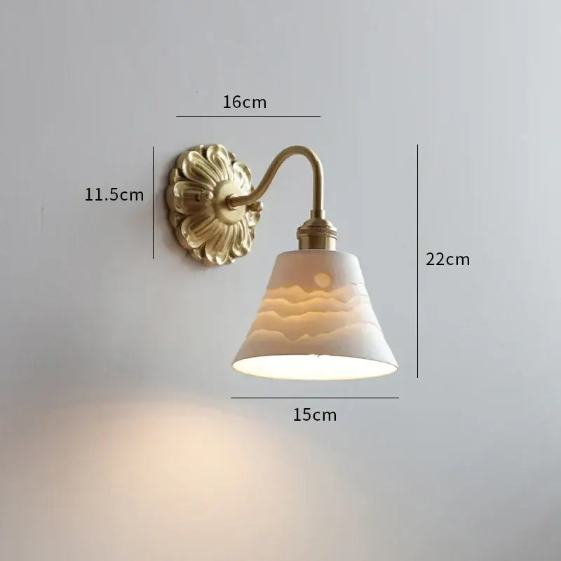 Antique brass wall lights with a fluted backplate and ceramic ball led lampshade for elegant bedroom decorbites lighting