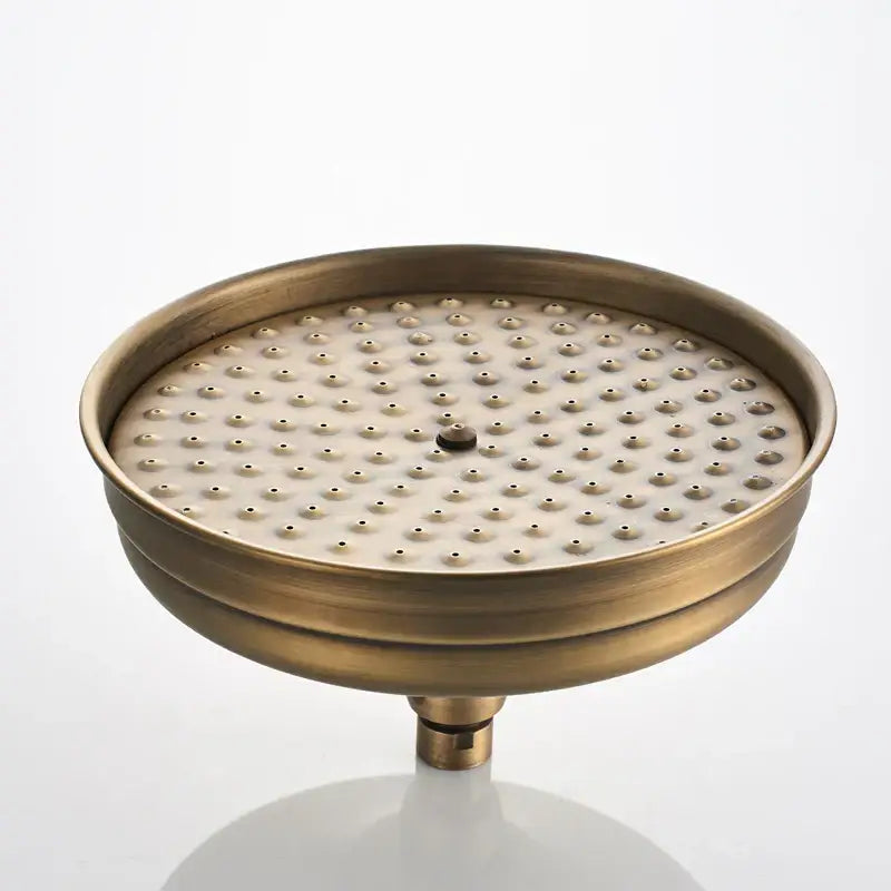Antique brass round shower faucet set featuring a circular shower head with evenly spaced nozzles and central adjustment knob
