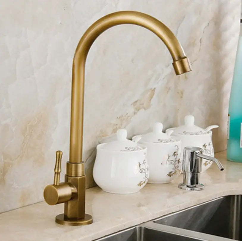 Antique brass single handle basin faucet with curved spout and brass finish for bathroom use