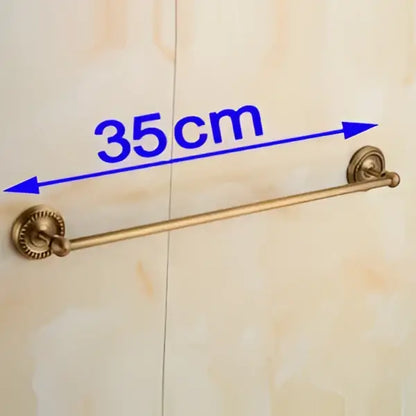 Antique brass single towel bar with gold-colored brass and ornate decorative ends for bathroom decor