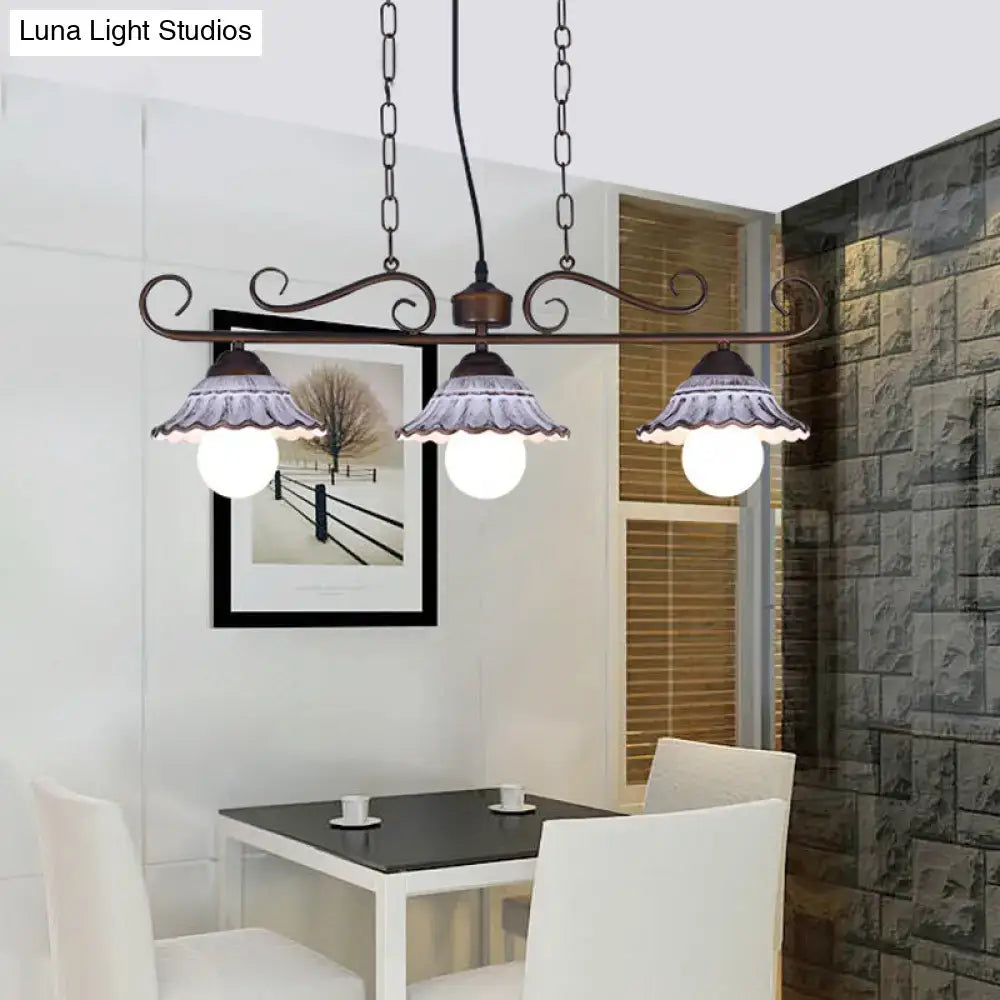 Antique bronze wrought iron island pendant lamp with three fluted frosted glass shades for kitchen island lighting