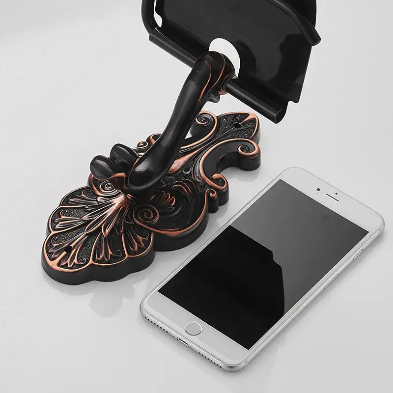 Antique bronze and black toilet paper holder with ornate bronze-finished phone stand featuring leaf and scroll design decorbites black brass