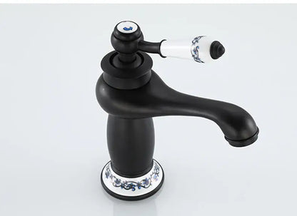 DecorBites™ antique bronze single handle bathroom faucet with black matte finish and white ceramic base with blue floral real shot details
