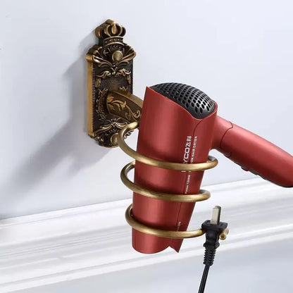 Red ycoz hair dryer with black mesh grille held in gold-toned decorbites bronze carved bath wall rack holder