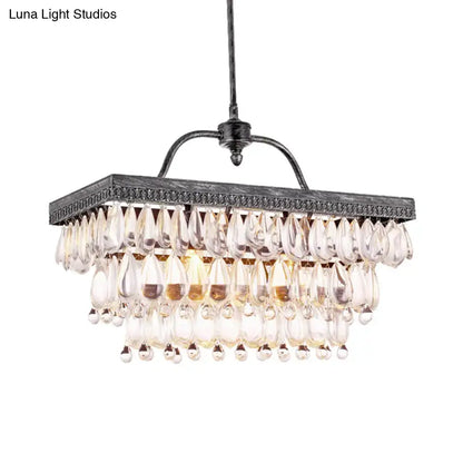 Antique black metal chandelier with multiple tiers of clear crystal teardrop accents for dining room lighting