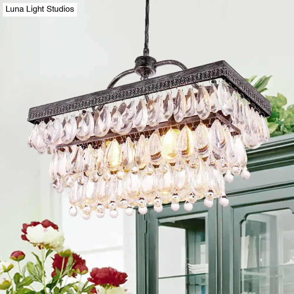 Antique bronze rectangular chandelier with clear crystal teardrop pendants and white spherical accents for dining room light