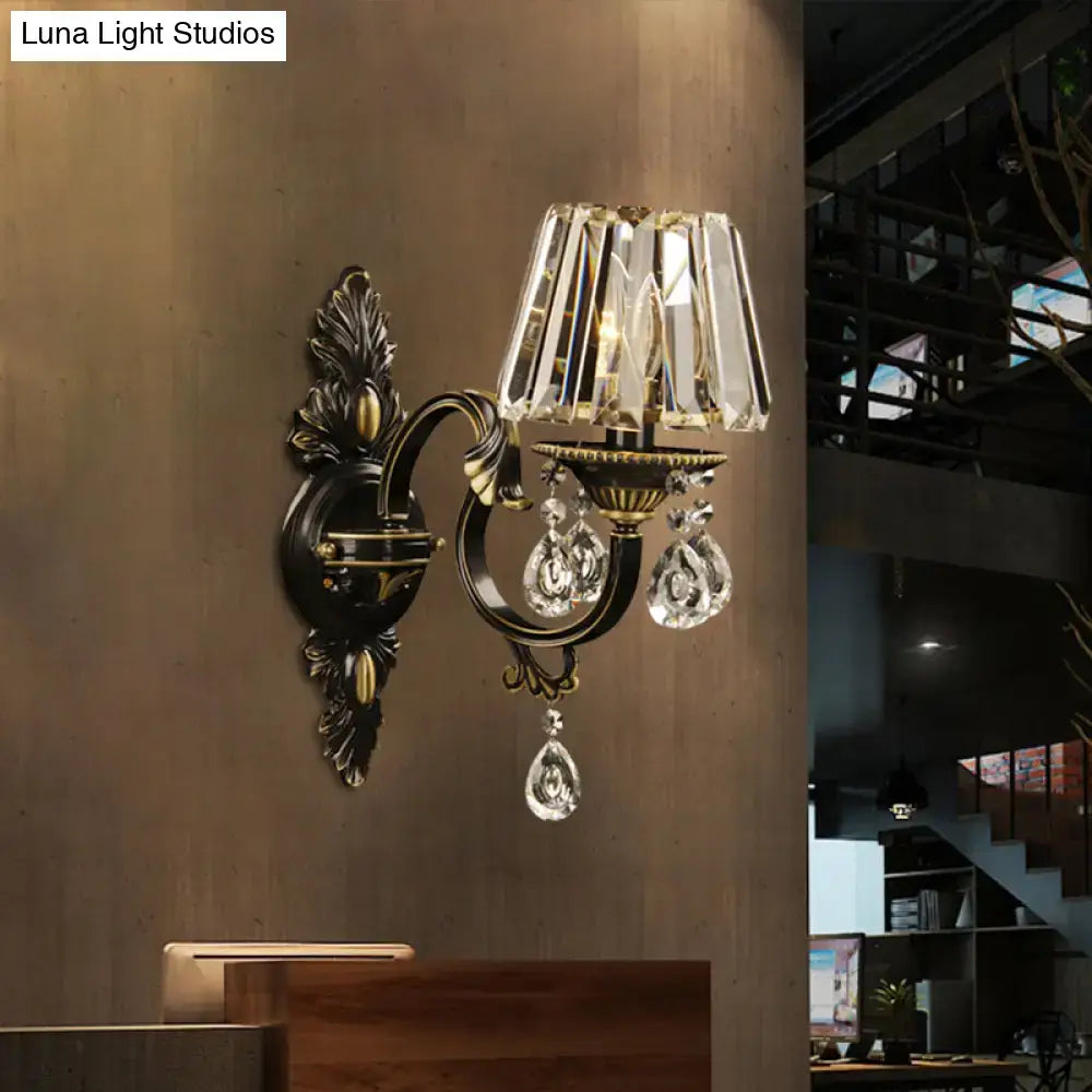 Antique bronze and crystal wall sconce with brass and black wrought iron featuring e14 light bulb base and teardrop crystals