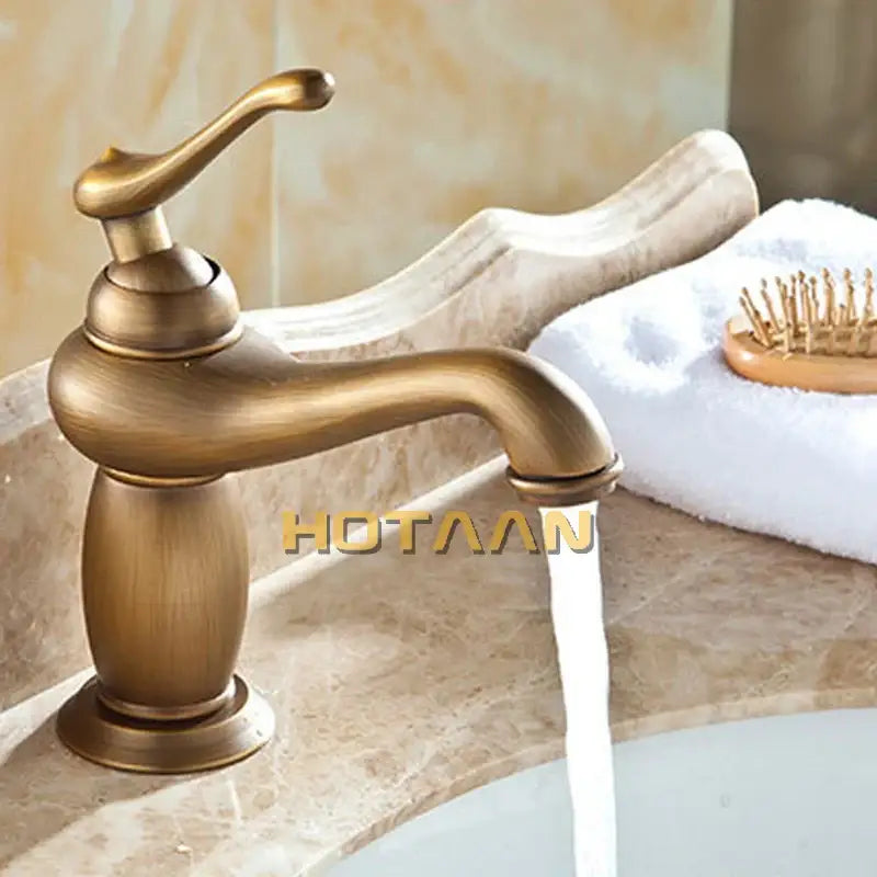 Antique bronze single handle basin faucet with brass finish and curved spout featuring vintage-inspired design