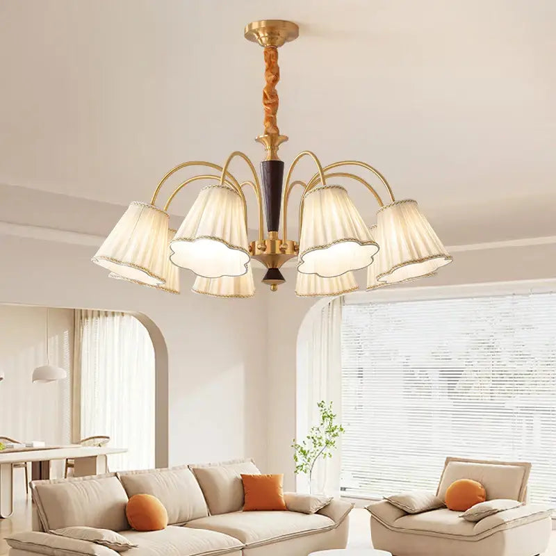 Antique copper chandelier with gold-toned twisted wooden stem and five cream pleated fabric shades for dining room