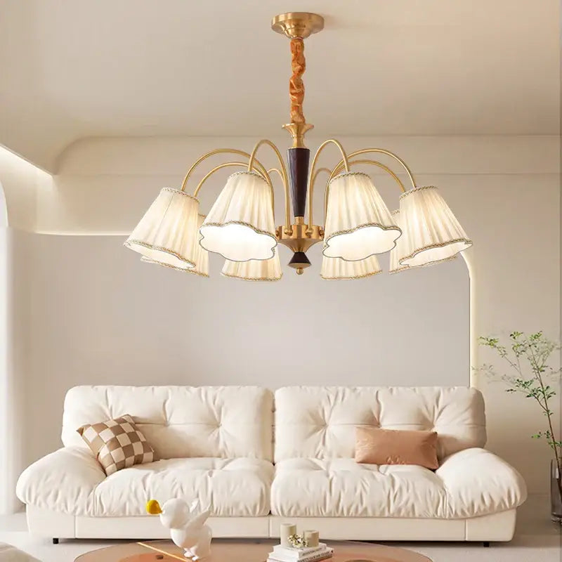 Antique copper chandelier with five cream pleated fabric shades and a twisted wooden stem for dining room lighting