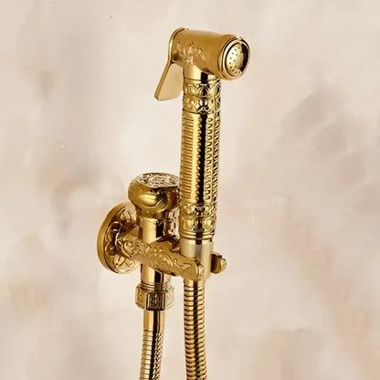 Gold-colored ornate brass bidet shattaf with engraved handle and textured hose for bathroom hygienic washing