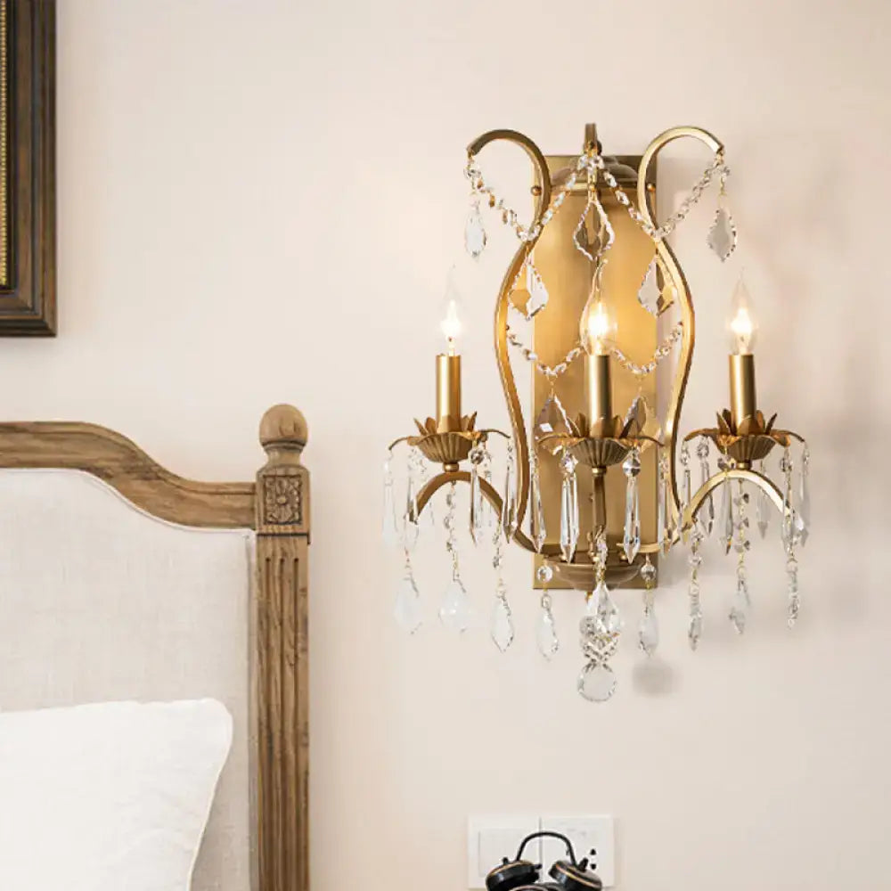 Antique gold candelabra wall light with black brass finish and crystal droplets for elegant dining room decor
