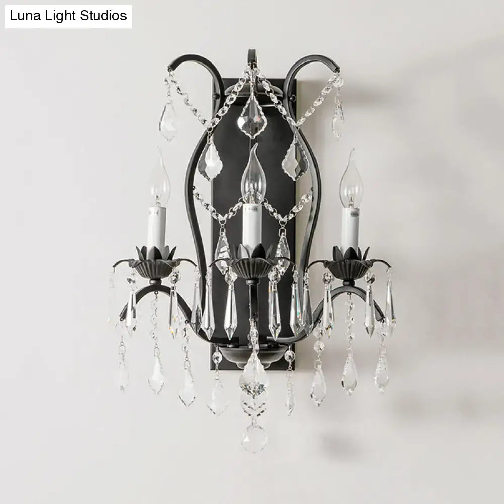 Elegant black wrought iron candelabra wall light with cascading clear crystal droplets for dining room decor