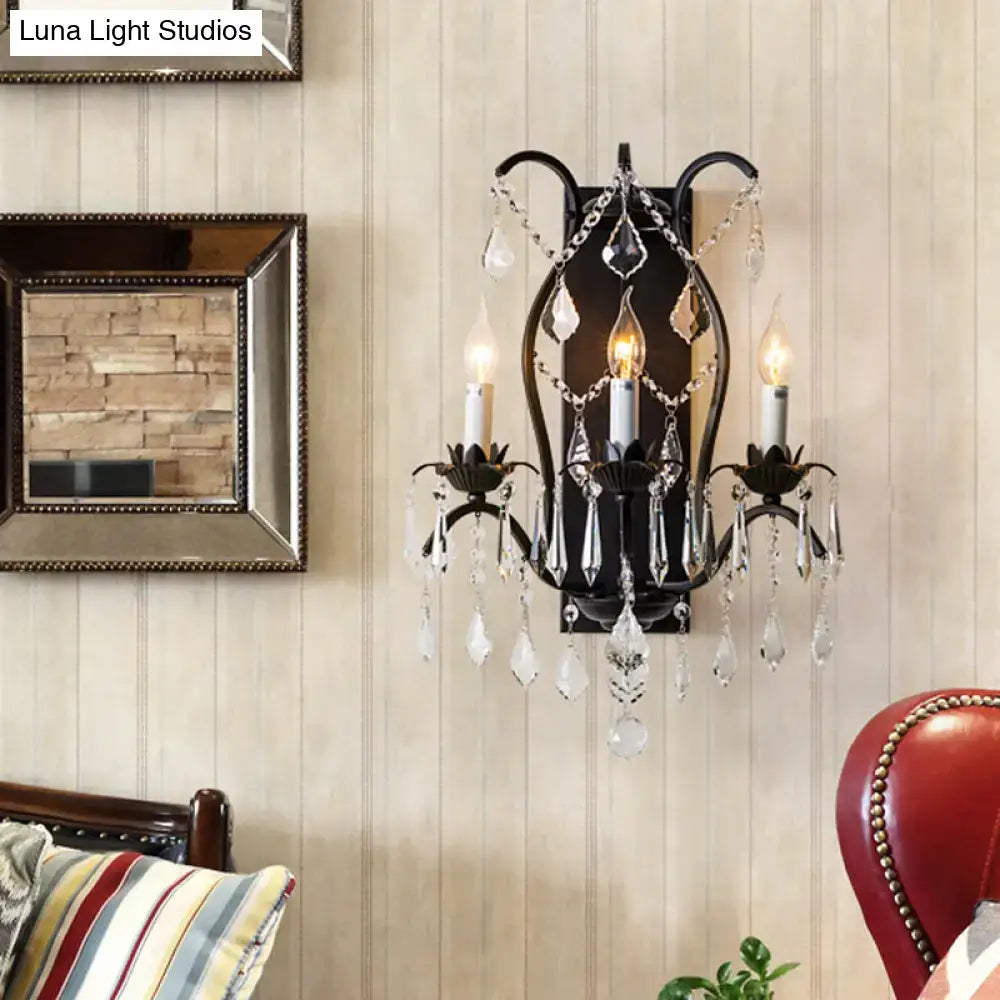 Black wrought iron candelabra wall light with crystal droplets and candle-style bulbs for elegant dining room use