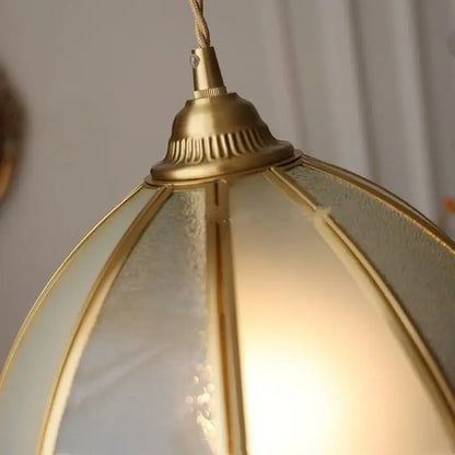 Gold-toned brass antique glass led pendant lamp with frosted panels and warm glow for kitchen lighting fixture