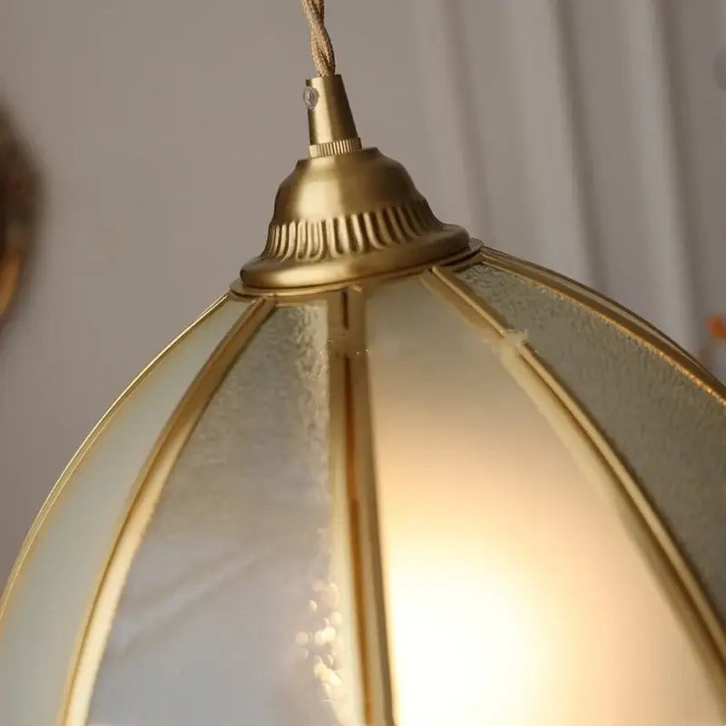 Gold-toned brass antique glass led pendant lamp with frosted panels and warm glow for kitchen lighting fixture