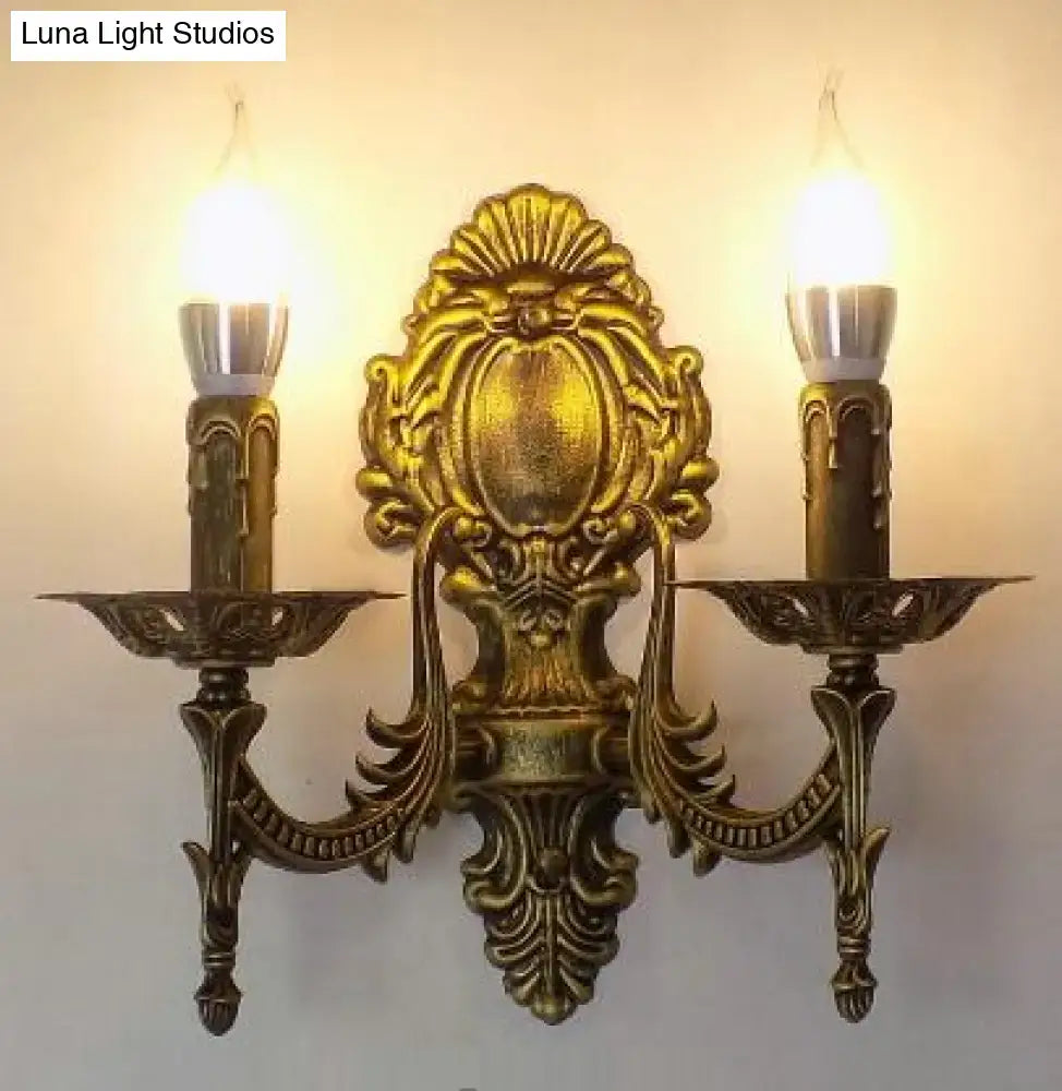 Antique gold retro european wall light with ornate baroque-inspired detailing and two candle-style bulbs for bedroom use