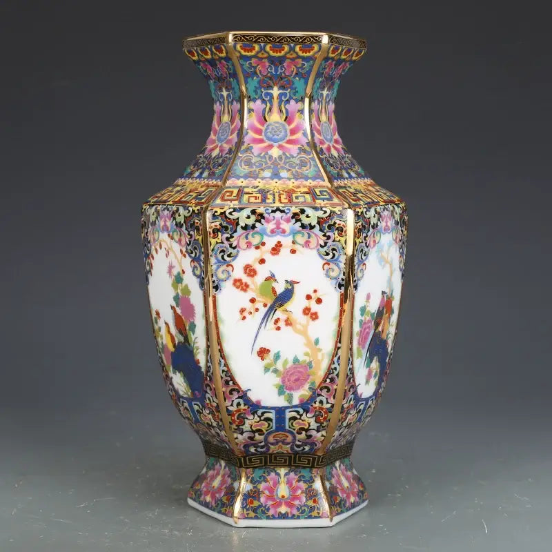 Antique hexagonal porcelain vase adorned with colorful floral and bird motifs in vibrant pinks and blues from vase collection