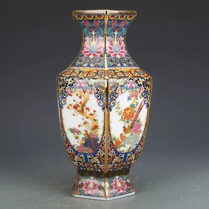 A hexagonal porcelain vase with vibrant enamel paintings of birds and flowers from an antique vase collection