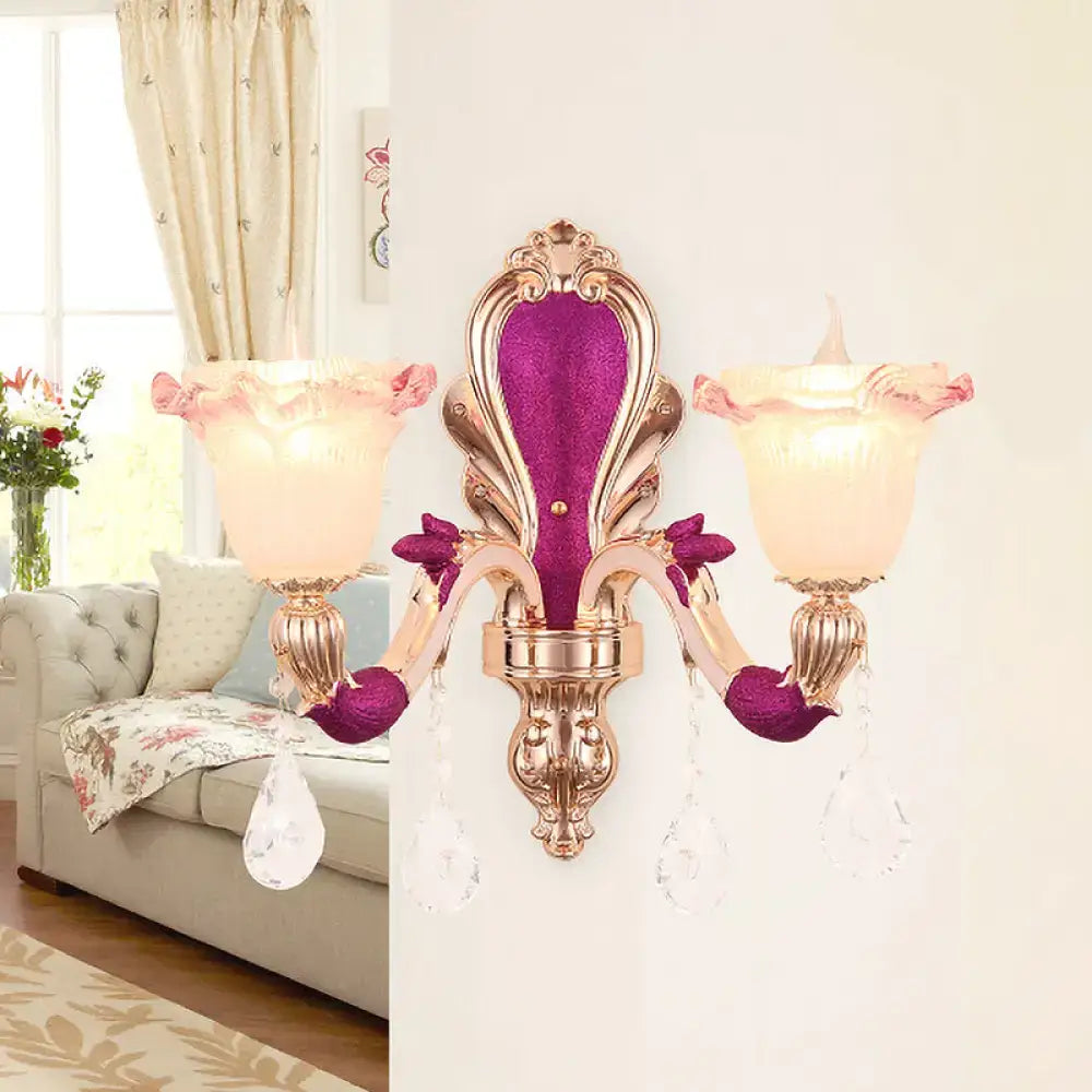 Elegant antique purple and gold double head mount light fixture with pink frosted glass shades and crystal droplets for bedroom