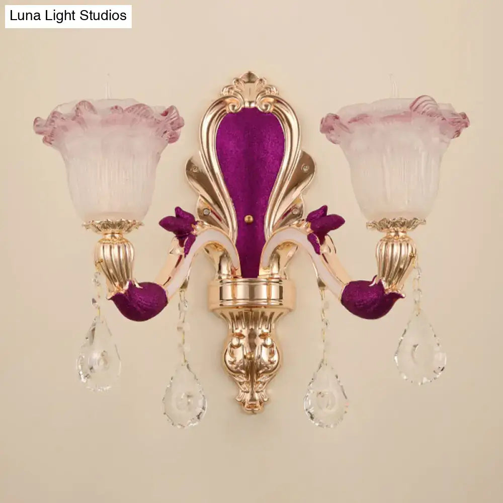 Elegant antique purple and gold double head mount light fixture with frosted pink glass shades and crystal accents